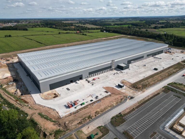 Aerial view of a newly built distribution warehouse and its yard nearing completion