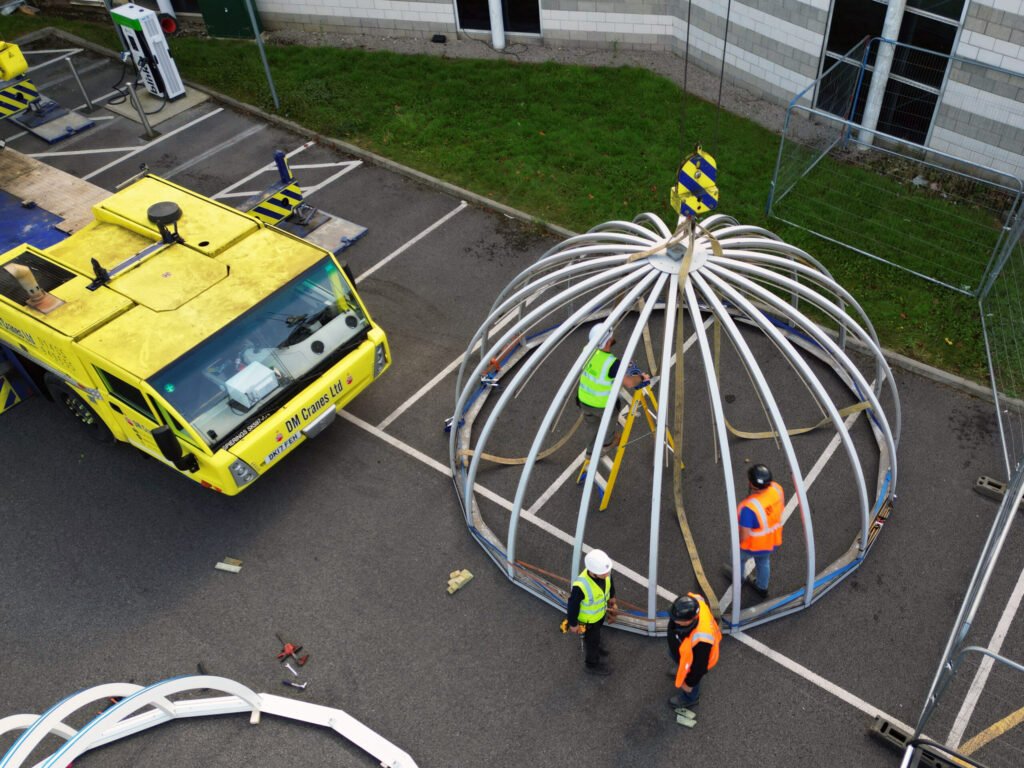 New steel cupola frame rigged on the ground before the lift